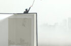 man with umbrella flying out of a illustrated book; surreal concept